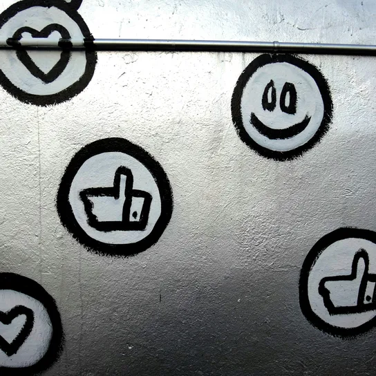 Silver surface spray painted with social media reacts, likes, smiles and love