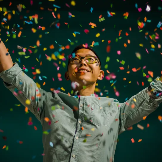 Person celebrating with confetti